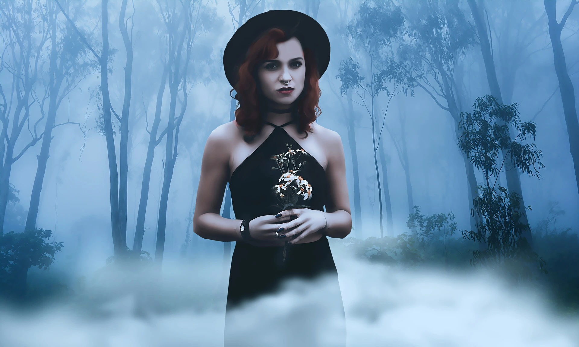 Woman in black dress and hat holding flowers in misty blue forest with fog around her.